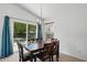 Dining area with dark wood table set, view of sliding doors, and pendant lighting at 3808 Hopper St, Raleigh, NC 27616