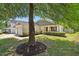 Inviting single-story home with lush lawn, decorative shrubs, and neutral siding at 3808 Hopper St, Raleigh, NC 27616