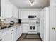 Bright kitchen features granite countertops, white cabinetry, and modern appliances for a clean, contemporary look at 3808 Hopper St, Raleigh, NC 27616