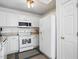 Well-lit kitchen equipped with white appliances, ample cabinet space, and a view of the breakfast area at 3808 Hopper St, Raleigh, NC 27616