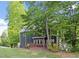 Exterior view of home, surrounded by mature trees at 404 Cary Pines Dr, Cary, NC 27513