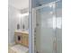 Bathroom featuring a tiled shower, double sinks, neutral paint, and a soft white rug at 404 Cary Pines Dr, Cary, NC 27513