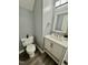 Bathroom with white vanity, mirror, and toilet at 404 Cary Pines Dr, Cary, NC 27513