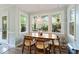 Bright dining area featuring modern light fixture, backyard view, and hardwood flooring at 404 Cary Pines Dr, Cary, NC 27513