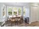 Dining area with large windows, hardwood flooring and a door to the backyard at 404 Cary Pines Dr, Cary, NC 27513