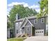 Charming two-story home featuring a gray exterior, brick foundation, and attached one-car garage at 404 Cary Pines Dr, Cary, NC 27513