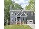 Charming two-story home featuring a gray exterior, brick foundation, and attached one-car garage at 404 Cary Pines Dr, Cary, NC 27513