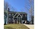 Charming two-story home with gray exterior, brick foundation, one-car garage, and a driveway with two cars at 404 Cary Pines Dr, Cary, NC 27513