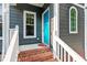 Inviting front porch with brick steps, white railings, and a bright blue door showcasing curb appeal at 404 Cary Pines Dr, Cary, NC 27513