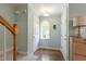 Light-filled hallway with hardwood floors, white trim, and an arched window adding architectural interest at 404 Cary Pines Dr, Cary, NC 27513