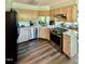 Kitchen with stainless steel appliances, light wood cabinets, and hardwood floors at 404 Cary Pines Dr, Cary, NC 27513