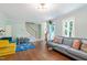 Inviting living room with a cozy seating area, open staircase, and large windows providing natural light at 404 Cary Pines Dr, Cary, NC 27513