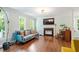 Bright living room with hardwood floors, fireplace, and large windows offering ample natural light at 404 Cary Pines Dr, Cary, NC 27513