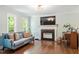 Bright living room with hardwood floors, fireplace, and large windows offering ample natural light at 404 Cary Pines Dr, Cary, NC 27513