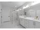 Modern bathroom with a large glass shower, double vanity, and neutral finishes at 411 Flat Rail Trl, Cary, NC 27511