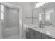 Modern bathroom featuring a tub, and a vanity with a large mirror and gray cabinets at 411 Flat Rail Trl, Cary, NC 27511