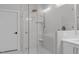 Walk-in shower featuring glass surround and dual shower heads, along with a built-in bench at 411 Flat Rail Trl, Cary, NC 27511