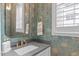 Elegant powder room featuring unique wallpaper and modern fixtures at 411 Flat Rail Trl, Cary, NC 27511