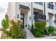 Modern townhome exterior featuring black awnings, manicured landscaping, and a welcoming front entrance at 411 Flat Rail Trl, Cary, NC 27511