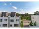 Exterior view of modern townhomes with rooftop decks and well-manicured landscaping at 411 Flat Rail Trl, Cary, NC 27511