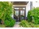 Inviting front door with manicured landscaping, a brick wall, and a seating area at 411 Flat Rail Trl, Cary, NC 27511