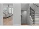 Hallway and staircase leading to a bedroom with a ceiling fan and white shuttered windows at 411 Flat Rail Trl, Cary, NC 27511