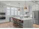 Modern white kitchen with stainless steel appliances, a center island, and stylish pendant lighting at 411 Flat Rail Trl, Cary, NC 27511