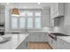 Bright kitchen with white cabinetry, quartz countertops, and stainless steel appliances at 411 Flat Rail Trl, Cary, NC 27511