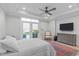 Bright main bedroom with natural light, ceiling fan, and a sitting area at 411 Flat Rail Trl, Cary, NC 27511