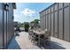 Outdoor dining set on a spacious rooftop deck with gray tile and a sunny sky at 411 Flat Rail Trl, Cary, NC 27511
