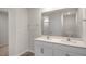 This bathroom features a double vanity with white cabinets, and a large mirror above the counter at 412 Ember St, Sanford, NC 27330