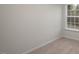 A light-filled bedroom with a large window, plush carpeting, and a calming neutral color palette at 412 Ember St, Sanford, NC 27330