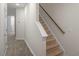 Inviting entryway featuring hardwood floors leading to a carpeted staircase at 412 Ember St, Sanford, NC 27330