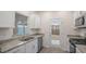 Modern kitchen boasts granite countertops, stainless appliances, and convenient access to backyard at 412 Ember St, Sanford, NC 27330