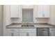 Well-lit kitchen features granite countertops, stainless steel appliances, and white cabinets at 412 Ember St, Sanford, NC 27330