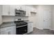 This kitchen includes stainless steel microwave, range, and granite countertops at 412 Ember St, Sanford, NC 27330