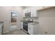 Modern kitchen with white cabinets, stainless steel appliances, and granite countertops, door to backyard at 412 Ember St, Sanford, NC 27330