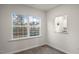 Cozy living area featuring hardwood floors, a large window, and a pass-through to the kitchen at 412 Ember St, Sanford, NC 27330