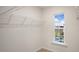 This walk-in closet provides ample storage with built-in wire shelving and a window for natural light at 412 Ember St, Sanford, NC 27330