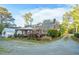 Backyard featuring a cozy deck, pergola, and mature trees at 418 S 2Nd St, Smithfield, NC 27577