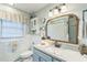 Bright bathroom with a granite sink, stylish fixtures, and decoratively tiled backsplash and flooring at 418 S 2Nd St, Smithfield, NC 27577