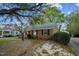 Charming brick home with mature trees and brick walkway to covered porch at 418 S 2Nd St, Smithfield, NC 27577