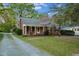 Quaint brick home with flowering tree and brick walkway to covered porch at 418 S 2Nd St, Smithfield, NC 27577