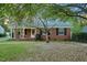 Charming brick home with mature trees and well-maintained front yard at 418 S 2Nd St, Smithfield, NC 27577