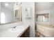 This bathroom has a sink with cabinet, a decorative mirror, plus a bathtub and shower combination, with a window at 43 Columbus Ct, Spring Lake, NC 28390