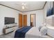 Bright bedroom with a ceiling fan, white walls, and a comfortable bed complemented by a modern entertainment center at 43 Columbus Ct, Spring Lake, NC 28390