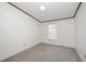 This bedroom features neutral carpet, white walls, a large window with blinds, and natural light at 43 Columbus Ct, Spring Lake, NC 28390