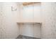 Walk-in closet with wallpapered walls, shelving, and a hanging rod providing ample storage space at 43 Columbus Ct, Spring Lake, NC 28390