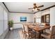 Elegant dining room featuring a wooden table set for six, complemented by a modern ceiling fan at 43 Columbus Ct, Spring Lake, NC 28390
