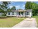This one-story home features neutral siding, green shutters, and a small front porch at 43 Columbus Ct, Spring Lake, NC 28390